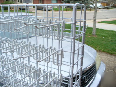 Rolling white metal spinner rack with hooks and baskets