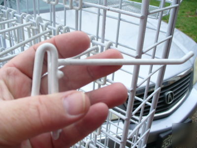 Rolling white metal spinner rack with hooks and baskets