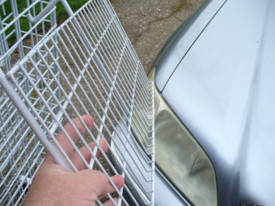 Rolling white metal spinner rack with hooks and baskets