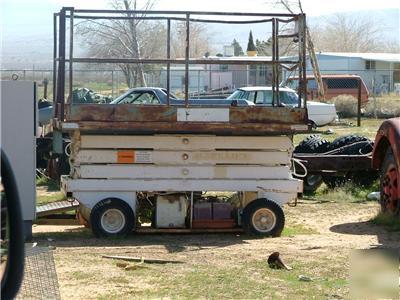 Scissor lift needs batteries great for building maint.