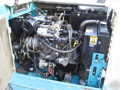 Tennant rider sweeper, hydraulic dump hopper, lp gas 